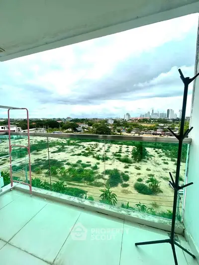 Spacious balcony with stunning cityscape view, perfect for relaxation and enjoying the skyline.