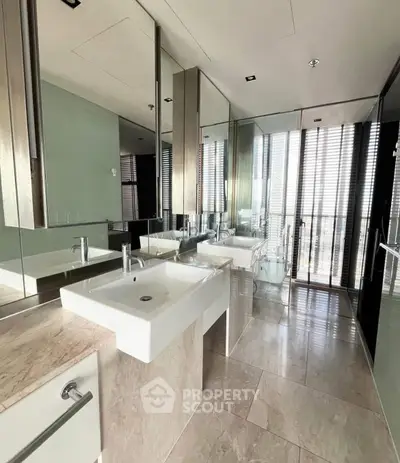 Luxurious modern bathroom with sleek fixtures and large mirrors