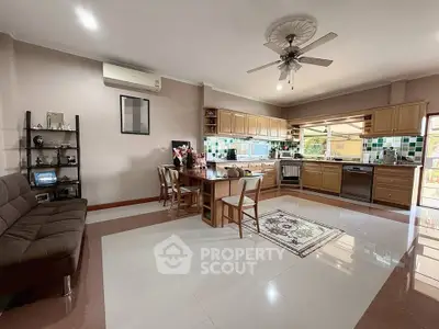 Spacious open-layout kitchen and living area with modern appliances and stylish decor.