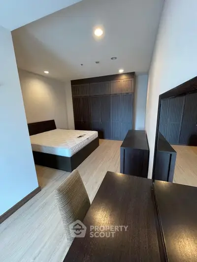Spacious bedroom with modern furnishings and ample closet space