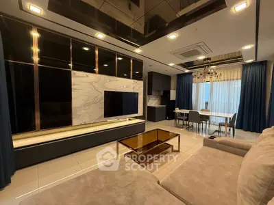 Luxurious modern living room with elegant decor and open dining area, featuring sleek furniture and ambient lighting.