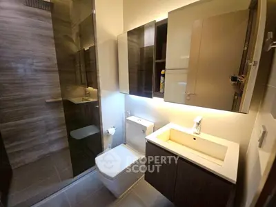 Modern bathroom with sleek fixtures and glass shower enclosure