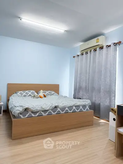 Spacious bedroom with modern decor and natural light
