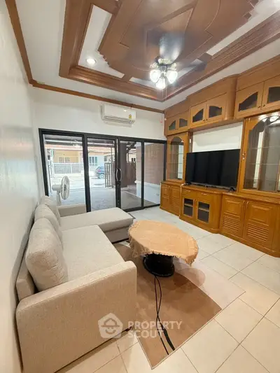 Spacious living room with elegant wooden cabinetry and modern furnishings