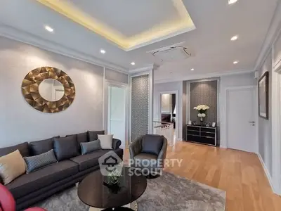 Elegant living room with modern decor, featuring stylish furniture and ambient lighting.