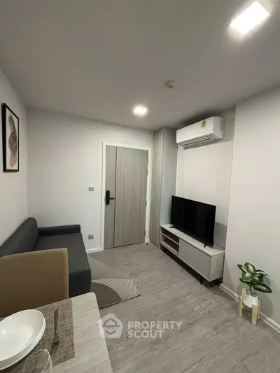 Modern living room with sleek furniture and air conditioning in a stylish apartment.