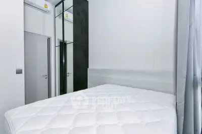 Modern bedroom with sleek design and mirrored wardrobe