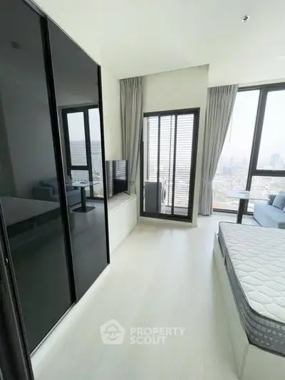 Modern bedroom with floor-to-ceiling windows and city view