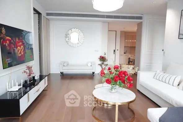 Luxurious living room with elegant decor and modern furniture, featuring a stylish TV setup and chic coffee table.