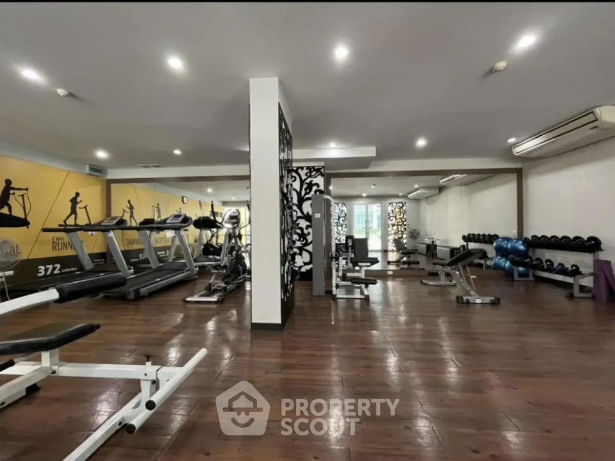 Spacious modern gym with state-of-the-art equipment and stylish decor