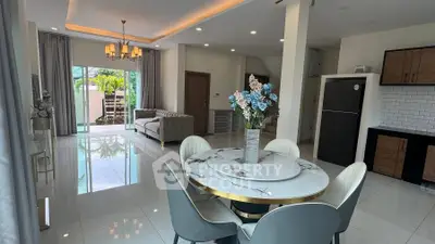 Elegant open-plan living room with modern dining area and stylish decor