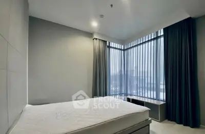Modern bedroom with large windows and minimalist design