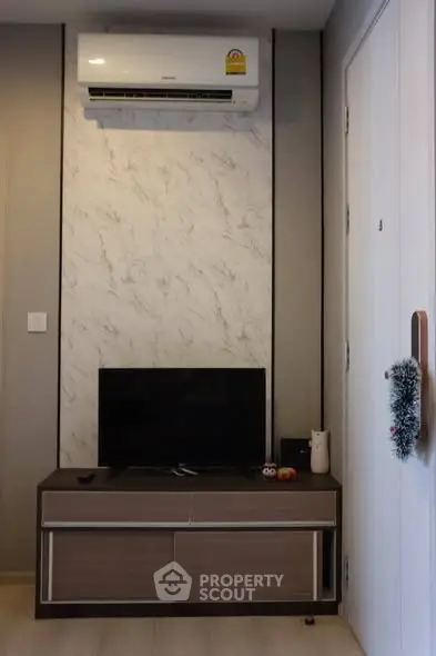 Modern living room with air conditioning and sleek TV stand, perfect for cozy urban living.