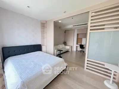 Spacious modern bedroom with stylish decor and adjacent study area