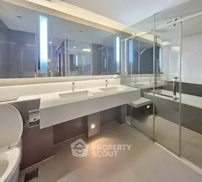 Luxurious modern bathroom with dual sinks and glass shower enclosure