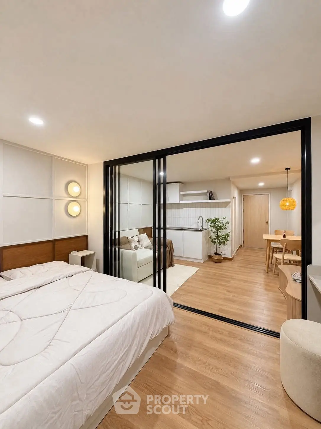 Modern studio apartment with open layout, featuring cozy bedroom and stylish kitchen area.