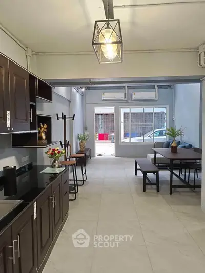 Spacious open-layout kitchen and dining area with modern decor and natural light.