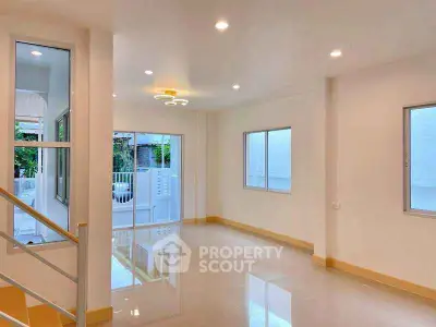 Spacious and bright living room with modern lighting and large windows