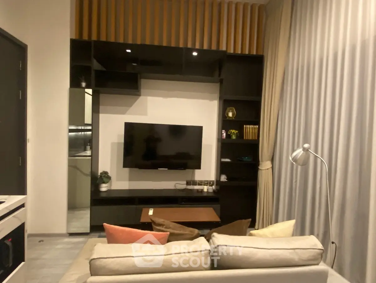 Modern living room with sleek TV unit and cozy sofa, perfect for relaxation.