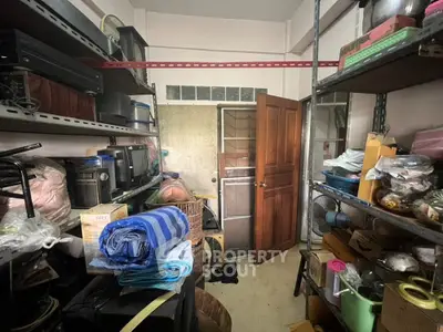 Spacious storage room packed with shelves and various household items, showcasing ample space for organization and potential for decluttering.