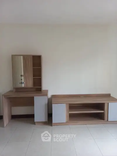 Minimalist interior with wooden furniture set against a neutral wall, ideal for modern living spaces.