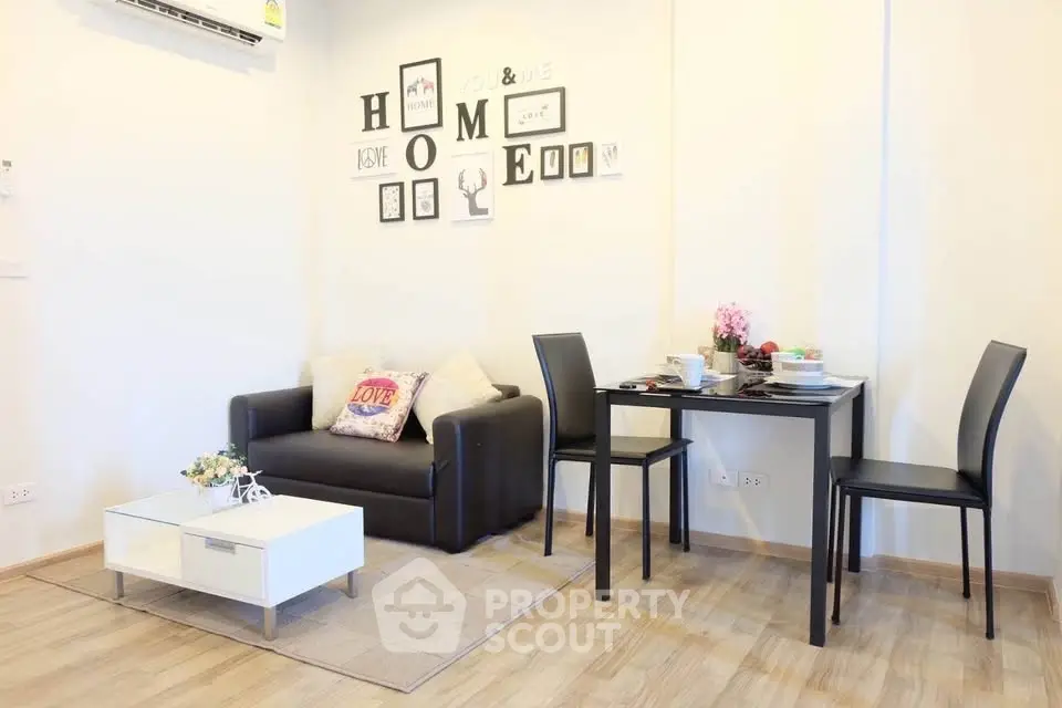 Charming living room with cozy sofa and dining area, perfect for modern living.