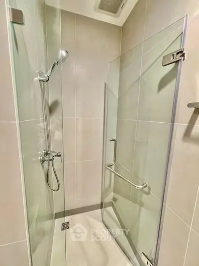 Modern shower area with glass enclosure and sleek fixtures in a contemporary bathroom.