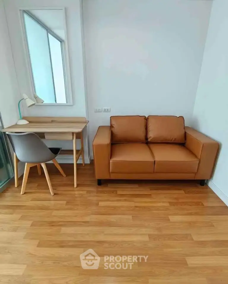Cozy study nook with leather sofa and wooden desk in modern apartment