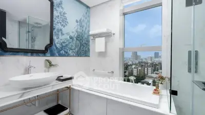 Luxurious bathroom with city view, elegant bathtub, and modern fixtures.