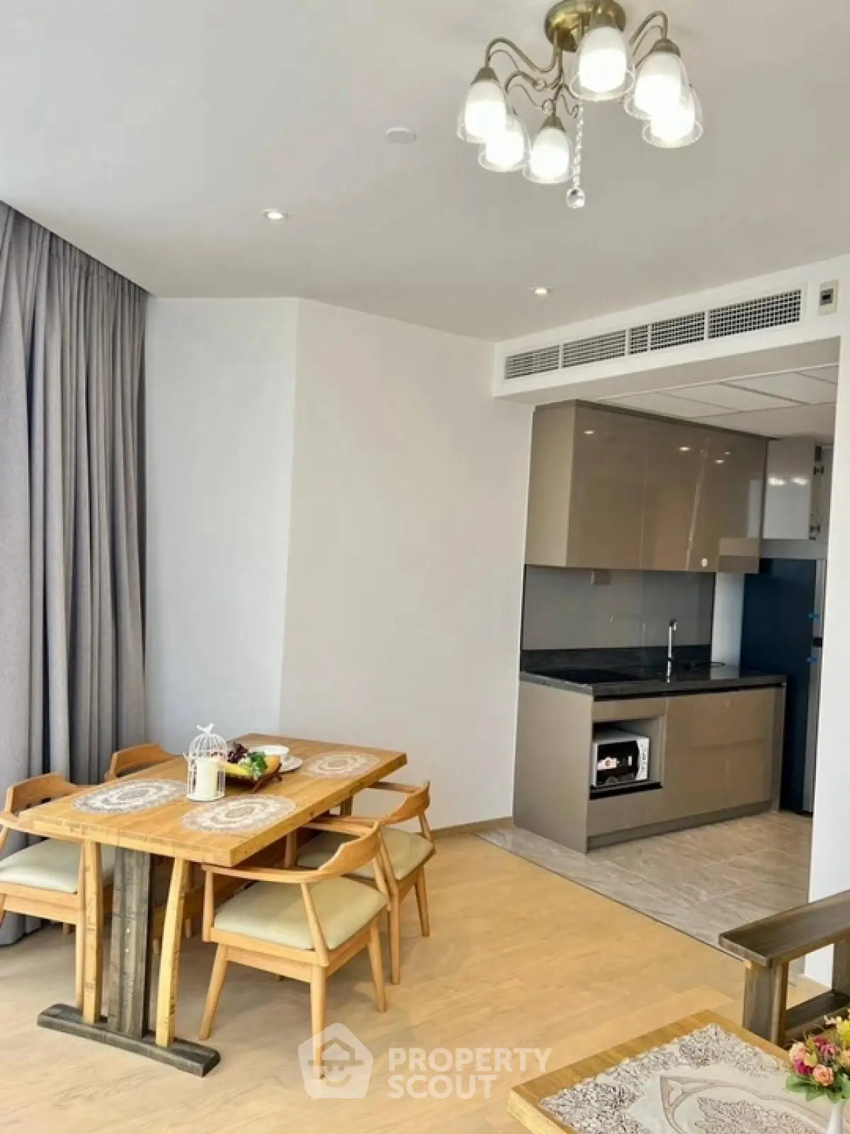 Modern dining area with open kitchen layout and elegant lighting