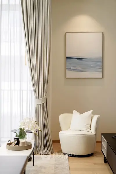 Elegant living room with plush armchair, modern art, and soft lighting