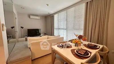 Modern living room with dining area, featuring cozy seating and elegant decor, perfect for urban living.