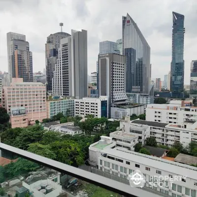 Stunning cityscape view from a high-rise balcony overlooking modern skyscrapers and lush greenery.