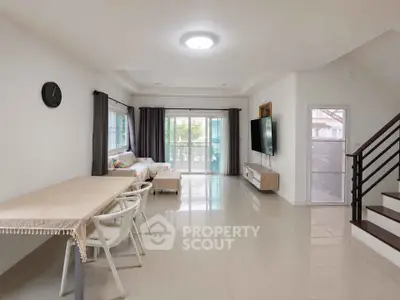 Spacious modern living room with elegant dining area and natural light