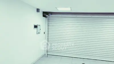 Spacious garage with modern roller door and bright lighting