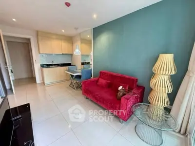 Modern living room with vibrant red sofa and stylish kitchen area