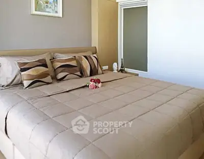 Cozy bedroom with stylish decor and comfortable bedding in modern apartment.