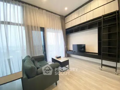 Modern living room with sleek furniture and floor-to-ceiling windows