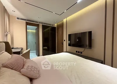 Luxurious modern bedroom with elegant decor and wall-mounted TV