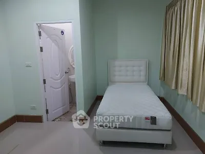 Cozy bedroom with single bed and attached bathroom in modern home