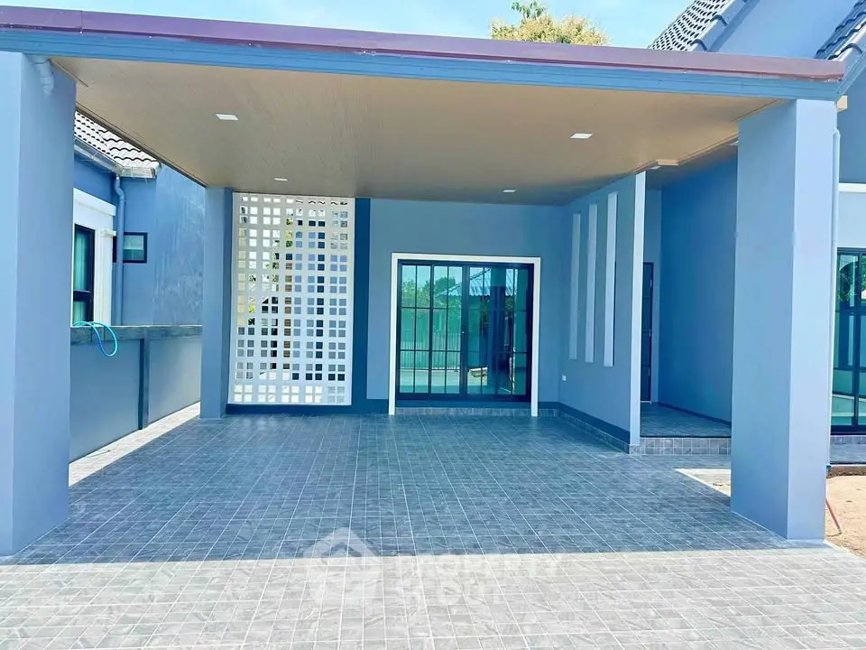 Modern blue house with spacious carport and sleek design