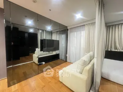 Modern living room with mirrored wall and cozy sofa in stylish apartment