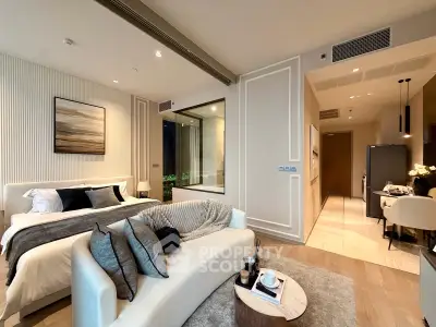 Luxurious modern bedroom with cozy living area and elegant decor