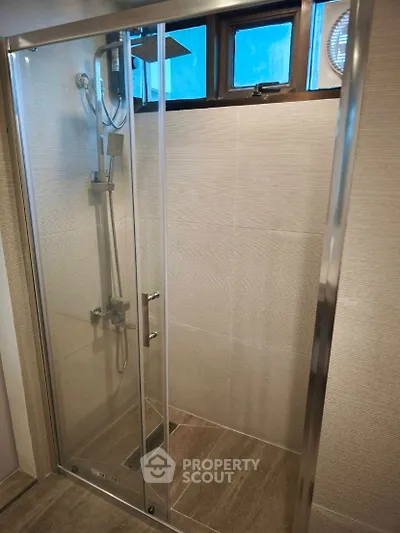 Modern bathroom shower with glass door and sleek fixtures
