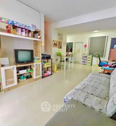 Spacious living room with modern decor and ample natural light, perfect for family gatherings.