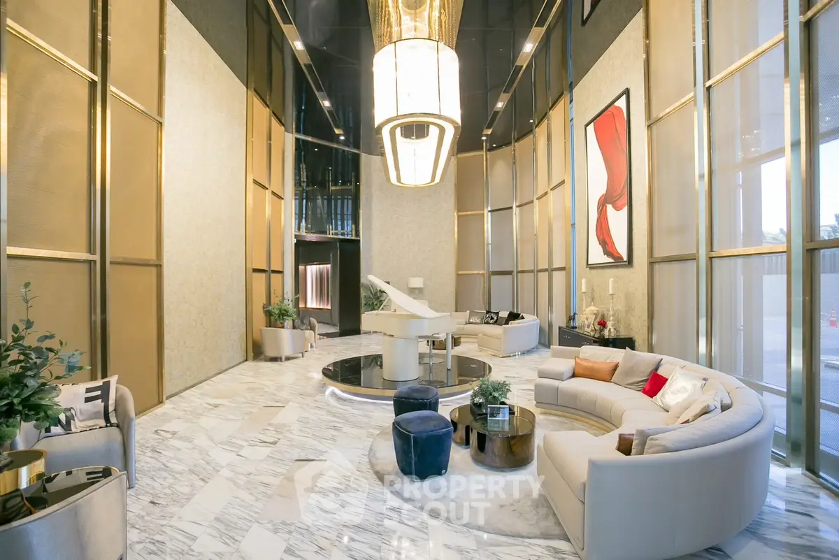 Luxurious modern lobby with elegant seating and grand piano, featuring high ceilings and stylish decor.