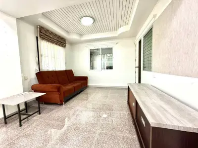 Spacious living room with modern sofa and elegant ceiling design