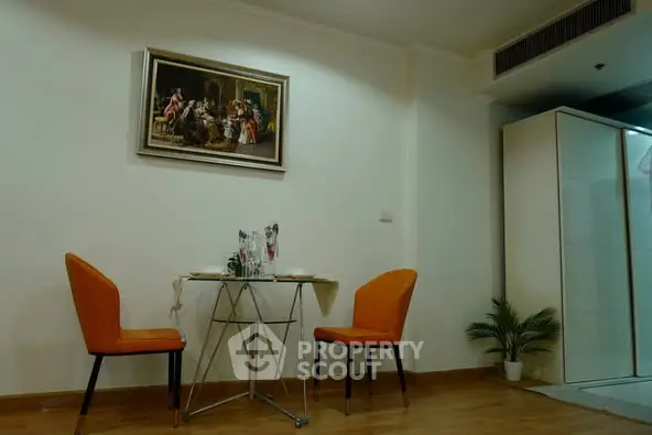 Cozy dining area with modern decor and elegant artwork in a stylish apartment.