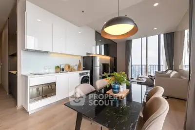Modern open-plan kitchen and living room with sleek design and city view.