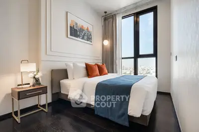 Luxurious bedroom with modern decor, large window, and city view in upscale apartment.
